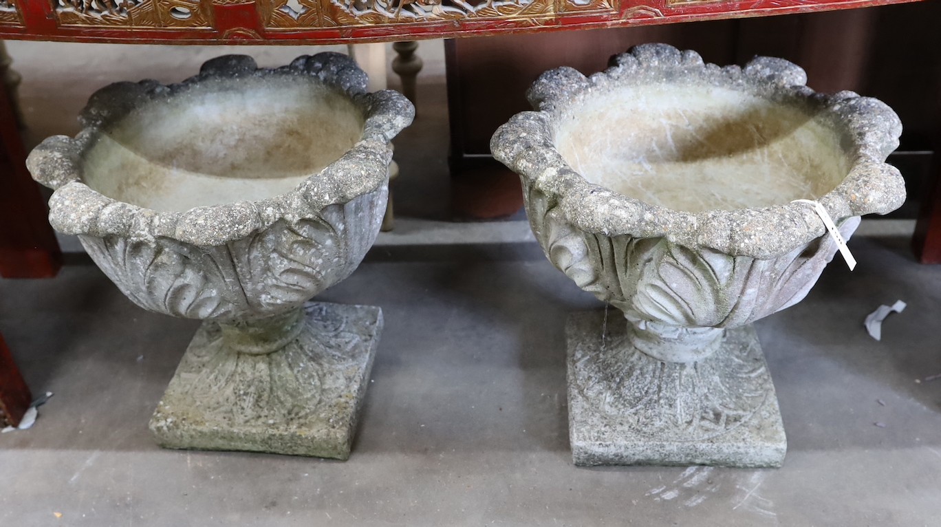 A pair of circular reconstituted stone garden planters moulded with acanthus leaves, diameter 50cm, height 43cm